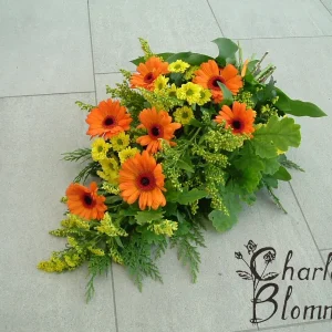 Sorgbukett i orange/gult.